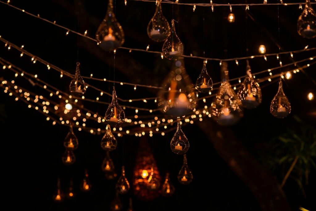 Clear crystal chandelier lit at night, its drops catching the light