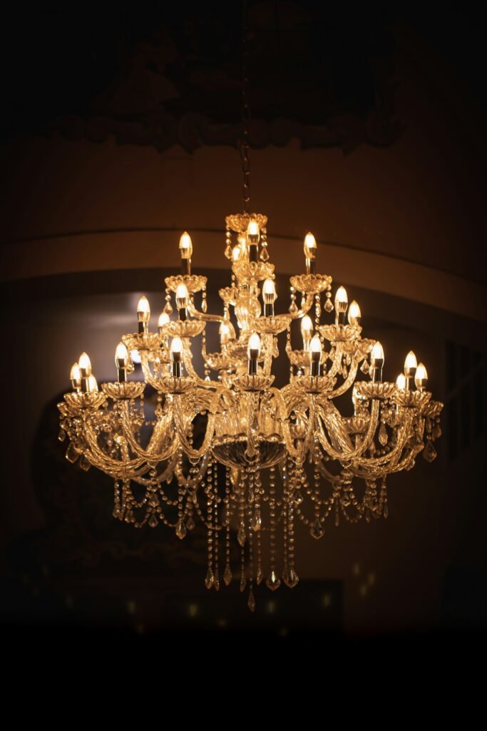Brass chandelier lit in a room